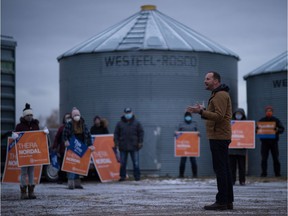 Saskatchewan NDP leader Ryan Meili, right, speaks to supporters during a rally in support of the party and local candidate Thera Nordal in a farmyard just north of Southey, Saskatchewan on Oct. 24, 2020.