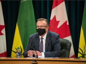 Saskatchewan Health Minister Jim Reiter sits wearing a mask prior to a news conference at the Saskatchewan Legislative Building in Regina, Saskatchewan on Oct. 28, 2020.