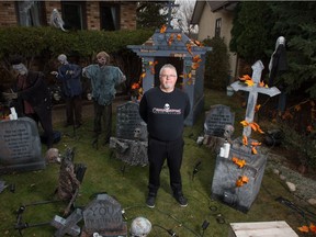 Pat Molloy stands amongst decorations in his halloween display on his front yard in Regina, Saskatchewan on Oct. 29, 2020. Molloy normally runs a halloween haunted house in his home, but has had to move things outdoors due to restrictions around COVID-19.