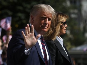 U.S. President Donald Trump waves to reporters as he departs with first lady Melania Trump for campaign travel to participate in his first presidential debate with Democratic presidential nominee Joe Biden in Cleveland, Ohio from the South Lawn at the White House in Washington, U.S., September 29, 2020. President Trump recently announced that he and the first lady have both tested positive for the coronavirus disease (COVID-19). Picture taken September 29, 2020.