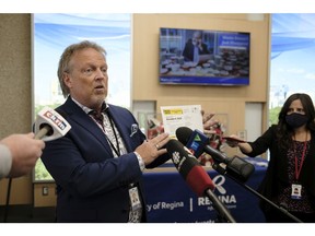 Jim Nicol, chief returning officer for Regina's 2020 municipal/school board elections holds up a voter information card. He was speaking at a news conference held Oct. 19, 2020 at City Hall
