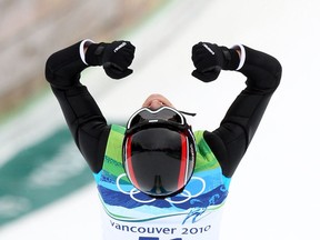 Gold medal winner Simon Ammann of Switzerland celebrates his victory in the men's ski jumping NH Individual Final Round in Whistler, B.C. February 13, 2010. (Jean Levac / Canwest News Service).