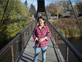 Hyon Suk Kim, principal clarinet player with the Regina Symphony Orchestra, stands on a bridge in south Regina on Oct. 8, 2020.