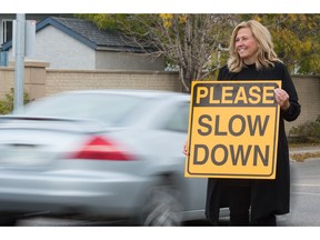 Regina Ward 4 city councillor and police commissioner Lori Bresciani is seen in this Leader-Post file image with a sign telling motorists to slow down at the intersection of Woodland Grove and Woodhams Drive on Oct. 1, 2020.
