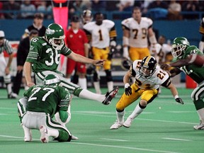 Dave Ridgway of the Saskatchewan Roughriders kicks the game-winning field goal, with Glen Suitor holding, against the Hamilton Tiger-Cats in the 1989 Grey Cup.
