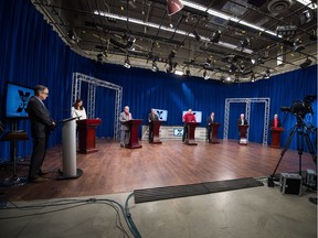 From left, moderator John Hopkins, stands next to Regina mayoral candidates Sandra Masters, Tony Fiacco, George Wooldridge, Darren Bradley, Michael Fougere, Jerry Flegel and Jim Elliott during the Regina mayoral debate held at Access Communications on Park Street in Regina, Saskatchewan on Nov. 2, 2020.