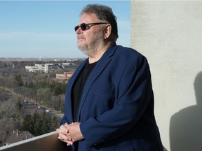 Dennis Fenwick, a retired judge, stands on the balcony outside his home in Regina, Saskatchewan on Nov. 4, 2020.