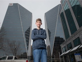 Nicholas Fuzesy stands between the Hill Towers in downtown Regina, Saskatchewan on Nov. 19, 2020. Fuzesy is a Regina high school student who is working on building a replica of Regina in the video game Minecraft.