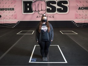 Carley Weisbeck, co-owner of BOSS Athletics, stands in the club's practice space on Dewdney Avenue in Regina, Saskatchewan on Nov. 26, 2020. The markings on the floor are for athletes to ensure social distancing.