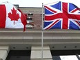 The Canadian flag flies alongside the British flag outside an Ottawa hotel, Sept 26, 2012.