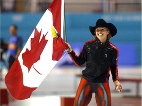 Speed skater Catriona Lemay Doan of Canada carries her country's flag and a smaller one of the Canadian province of Saskatchewan, where she was born, as she celebrates winning the women's 500m Olympic speedskating competition in Salt Lake City, Thursday. Doan took the gold in a combined time of 74.75 seconds, ahead of Germany's silver medalist Monique Garbrecht-Enfeldt, 74.94 seconds, and Germany's bronze medalist Sabine Voelker, 75.19 seconds. (Barton Silverman/The New York Times)