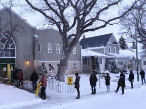 People queue outside a polling place at St. Mary's Anglican Church.
