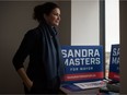 Sandra Masters stands by a window at her campaign office on Prince of Wales Drive in Regina, Saskatchewan on Oct. 28, 2020 while running to be mayor of Regina.