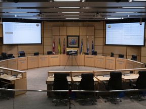 Two large screens project the results of the municipal election at City Hall on Nov. 9, 2020.