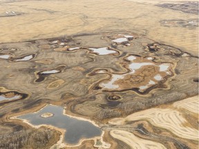 This October 2017 file photo from the Quill Lakes area shows cultivated land with wetlands in the mididle and a producer's field drained of its wetlands in the top portion. MICHAEL BELL / Regina Leader-Post.