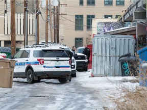 Police gather in the alley behind the 2100 block of Albert Street in Regina, Saskatchewan on Dec. 8, 2020. The Regina Police Service and the Saskatchewan Coroners Service are investigating a death, with the discovery at about 11:05 a.m. of a deceased adult female in the alley behind the 2100 block of Albert Street.  EMS confirmed her deceased and now we are assisting the Coroner in determining more about the circumstances of her death.
