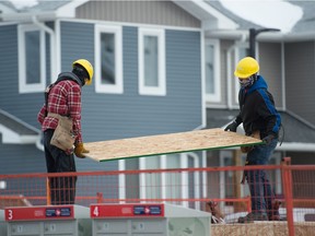 Workers build homes for Habitat for Humanity on Edgar Street in Regina on Dec. 17, 2020.