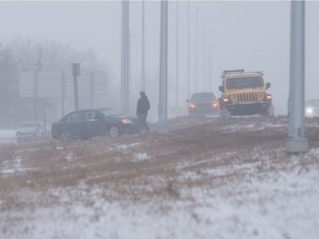Vehicles sit in the ditch along Ring Road during a snow storm in Regina, Saskatchewan on Dec. 22, 2020.