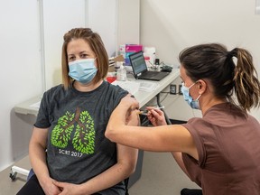 Respiratory therapist Karen Schmid receives the Pfizer Covid-19 vaccine from RN Lianne Korte, becoming the first person in Saskatoon to receive the vaccine on Dec. 22, 2020.