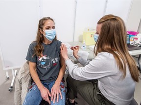 Registered nurse Kathy Pickerl receives the Pfizer COVID-19 vaccine from RN Cheryl Dow, becoming the second person in Saskatoon to receive the vaccine  on Dec. 22, 2020.