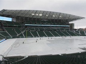 Crews work to make an enormous skating rink at Mosaic Stadium. Registration for the public skate starts today; the first skate is on Dec. 31.