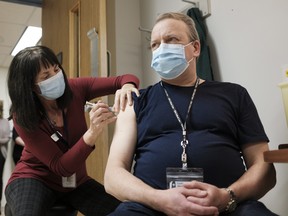 Heather Witzel-Garnhum, nurse clinician, injects Dr. Jeffrey Betcher, critical care lead, with the Pfizer-BioNTech COVID-19 vaccine. Betcher says we're through the worst of the third wave, but still, he urges caution as things start to open up.