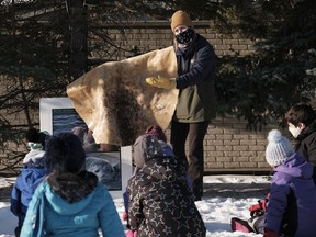 Lori Milligan shows a seal hide to students during in an outdoor educational event at Jack Mackenzie School. The Grades 3s and 4s have been learning all about the Arctic. To wrap up their study, staff from Regina Public Schools' Outdoor Education Department set up an Arctic nature trail.