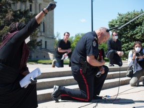 Regina Police Chief Evan Bray kneels during a Black Lives Matter rally in Regina on June 5, 2020.