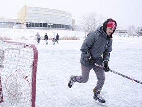 Tyler Lees plays shinny behind the Sandra Schmirler Centre, despite the Mayor and Regina Fire and Protective Services advising against such activity.