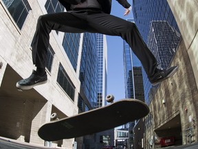 REGINA, SASK :  June 11, 2020  Ñ  Regina Christian School grade 12 student Tristan Taylor performs a kick flip on his skateboard downtown in Regina on Thursday, June 11, 2020.   TROY FLEECE / Regina Leader-Post

Its not often you'd see a teenager in a suit riding a skateboard in back alley downtown Regina.  Plenty of planning went into this photo to give it visual impact.  Working with two studio lights and a fisheye lens, while managing traffic in the alley, helped me make a unique portrait for graduating grade 12 during the pandemic.
