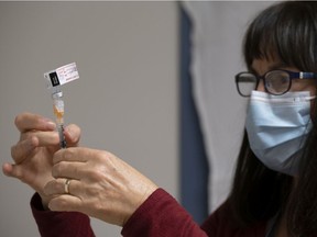 Heather Witzel-Garnhum, nurse clinician, prepares a syringe with the Pfizer-BioNTech COVID-19 vaccine at the Regina General Hospital in Regina on Tuesday Dec. 15, 2020. Michael Bell/Canadian Press
