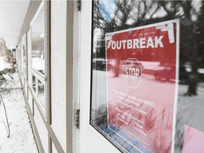 An outbreak warning is posted to a door at Parkside Extendicare.