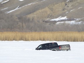 This file image from 2014 shows a truck broken through the ice in March 2014 between Pasqua and Echo lakes. The province has re-issued a thin ice warning given unseasonably warm temperatures currently.
