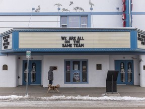 TOP 9 SASKATOON,SK-- APRIL 01/2020-0402 news quiet city week 2- A man walks his dog past the Broadway Theatre in Saskatoon, SK on Wednesday, April 1, 2020.