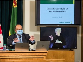 Saskatchewan's chief medical health officer Dr. Saqib Shahab speaks to media during a news conference regarding the COVID-19 vaccine rollout, held in the Saskatchewan Legislative Building in Regina, Saskatchewan on Jan. 6, 2020. On the screen at frame right is an ASL interpreter.