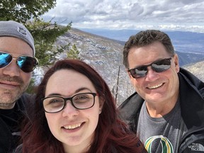 Warren Woods, right, is shown in March of 2019 with his son, Chris, and daughter, Nicole, in Kelowna, B.C. Warren Woods has been hospitalized since early December with COVID-19.