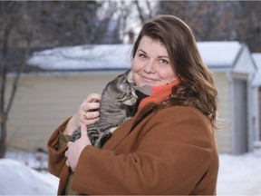 Rachel Molnar holds foster cat Oz near her Heritage neighbourhood home. Molnar is a longtime volunteer with Regina Cat Rescue where she fosters cats and kittens.