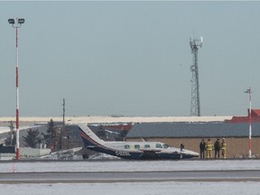 An airplane sits belly down on the tarmac at the Regina International Airport in Regina, Saskatchewan on Jan. 12, 2020. Atmospheric waves can be seen in the photo, due to the distance from which the image was captured with a telephoto lens.