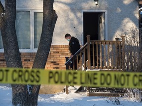 Police work at a home on the 700 block of Athol Street in Regina, on Jan. 16, 2021. After responding to a call that a woman had been shot, police found a woman at the scene with what they reported were serious injuries. She has since died and a homicide investigation is underway.