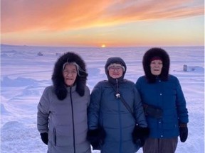 Cambridge Bay, Nunavut, residents (left to right) Mary Akariuk Kaotalok, Helen Navalik Blewett and Bessie Pihoak Omilgoetok celebrate the return of the sun on Wednesday, Jan. 13, 2021.