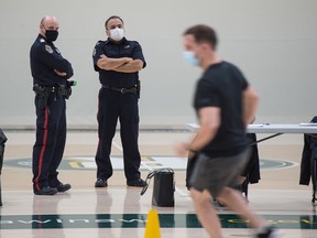Sgt. Colin Hegi, recruiting officer with Regina Police Service, human resources, left, and Const. Dale McArthur, Indigenous recruitment liaison officer for the police service, stand together during a POPAT testing session as part of their recruiting duties during an event held at the University of Regina on Jan. 19, 2021.