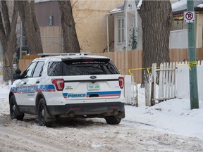 A police vehicle sits in front of a home on the 1700 block of Quebec Street in Regina, Saskatchewan on Jan. 20, 2021.