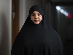 Sharifa Abubakar, a Somali refugee, stands in the hallway near the office of Prairie Somalis in Regina, Saskatchewan on Jan. 20, 2021. Abubakar's husband is stuck overseas partly due to COVID-19 delays.