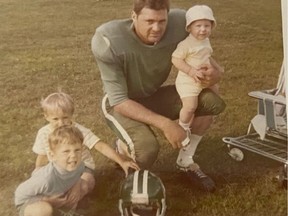 Saskatchewan Roughriders safety Bruce Bennett with his sons Brad (on Bruce's knee), Bill (white shirt with hand on the helmet) and Bob in the early 1970s. Photo courtesy Bennett family.