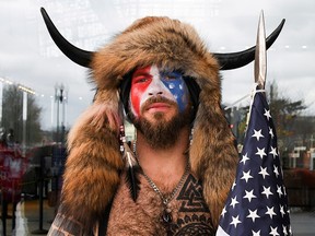 Jacob Anthony Chansley, also known as Jake Angeli, of Arizona, poses with his face painted in the colours of the U.S. flag as supporters of U.S. President Donald Trump gather in Washington, January 6, 2021.