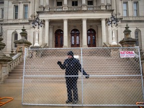 Fencing is put up amid beefed up security ahead of planned protests at the state Capitol building in Lansing, Michigan, U.S., January 15, 2021.