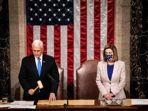 Vice President Mike Pence and House Speaker Nancy Pelosi preside over a Joint session of Congress to certify the 2020 Electoral College results after supporters of President Donald Trump stormed the Capitol earlier in the day on Capitol Hill in Washington, DC on January 6, 2020. - Members of Congress returned to the House Chamber after being evacuated when protesters stormed the Capitol and disrupted a joint session to ratify President-elect Joe Biden's 306-232 Electoral College win over President Donald Trump.