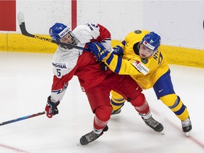The Czech Republic's Stanislav Svozil, left, shown during a Dec. 26 world junior hockey championship game against Sweden, was selected by the Regina Pats in the first round of the CHL's 2020 import draft.