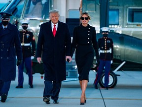 Outgoing U.S. President Donald Trump and First Lady Melania Trump step out of Marine One at Joint Base Andrews in Maryland on January 20, 2021.