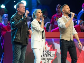 From left, Brad Johner, Beverly Mahood and Jeffery Straker sing together during Telemiracle held at the Conexus Arts Centre on Lakeshore Drive in Regina, Saskatchewan on Mar. 8, 2020.